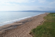 The view south from Cabot’s Landing Park is a grand sweeping beach that connects smaller headlands all the way to the far highlands.  The beach often shows cusps, and selective sorting of sands and gravels by wind and waves.